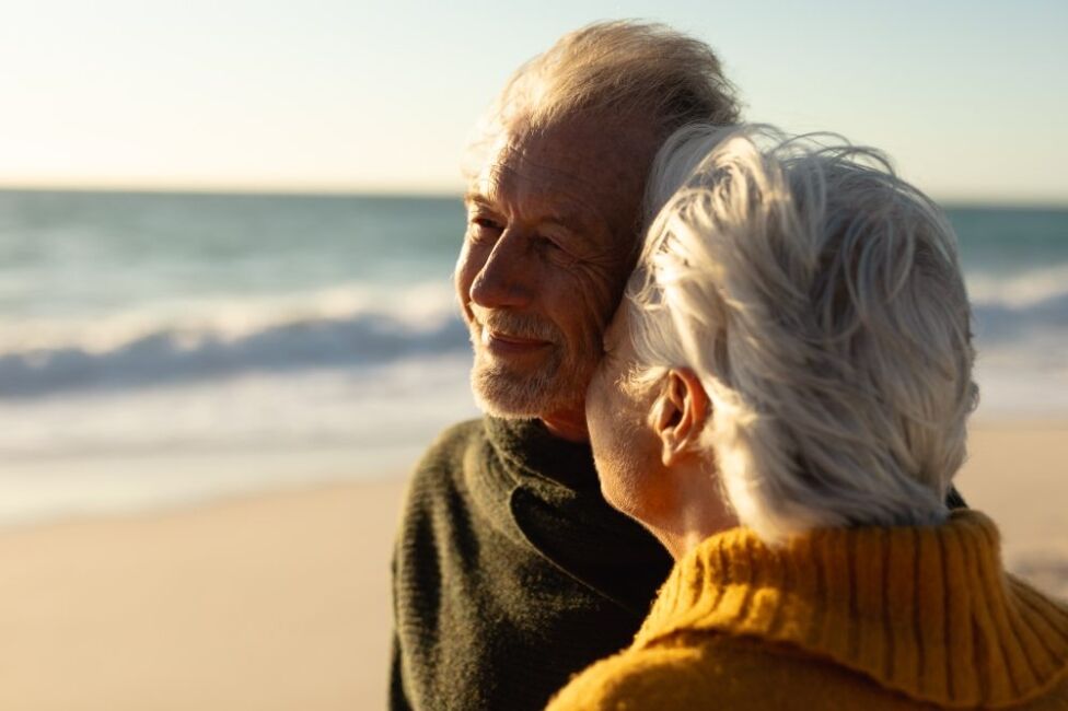 Senior couple walking along the beach