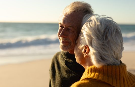 Senior couple walking along the beach