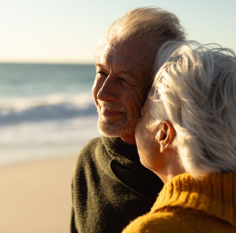 Senior couple walking along the beach