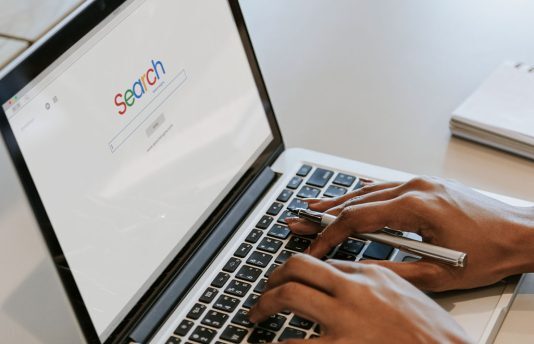 Person using search engine on a laptop