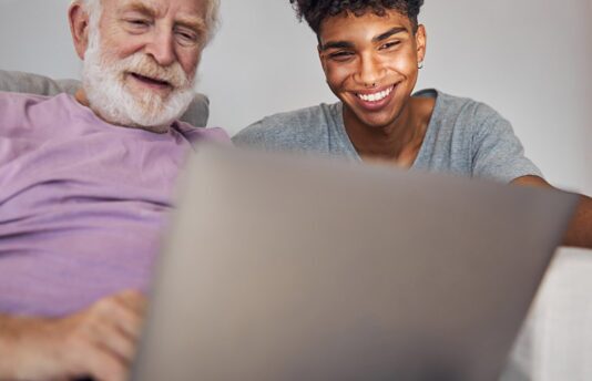 Grandfather & grandson using a laptop